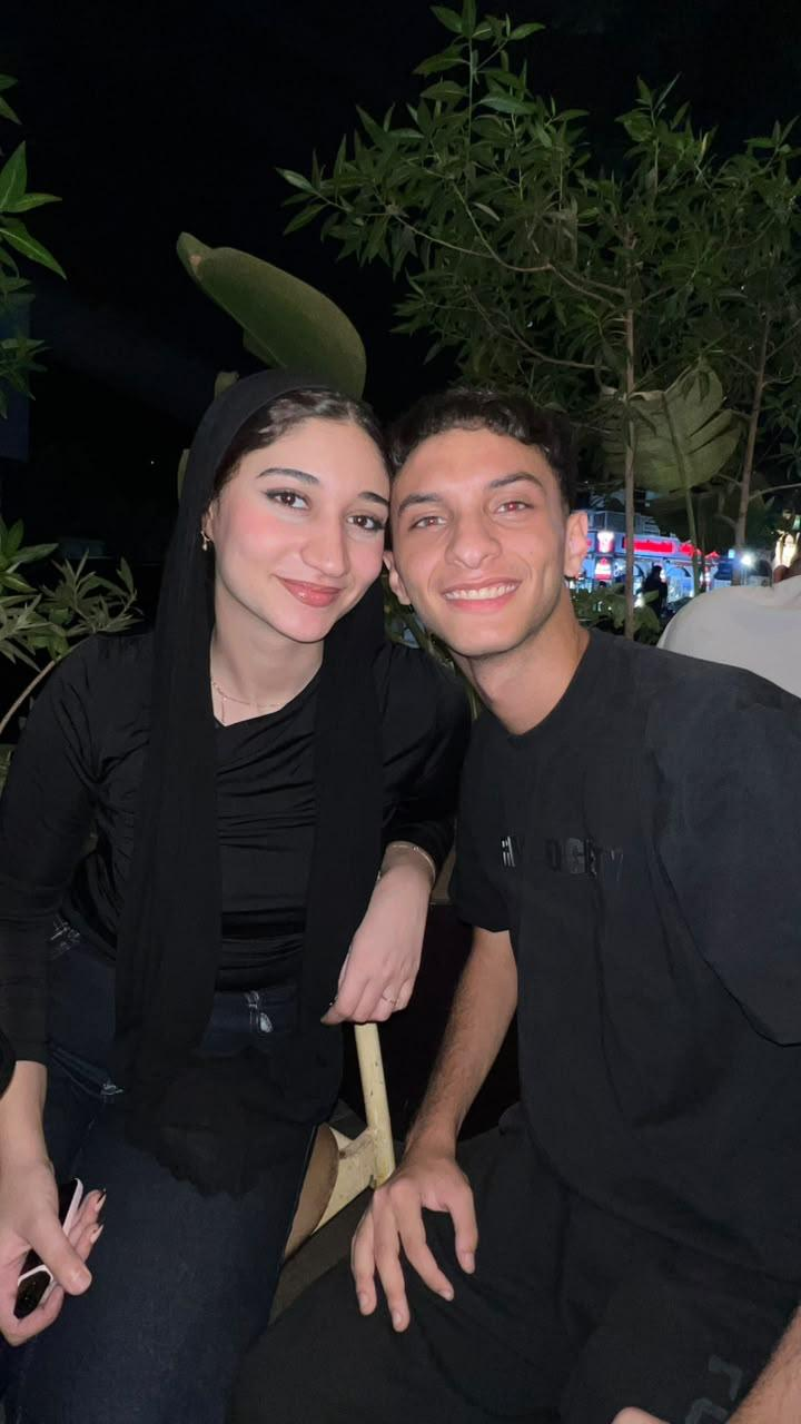 Wed and 3amour smiling together outdoors at night